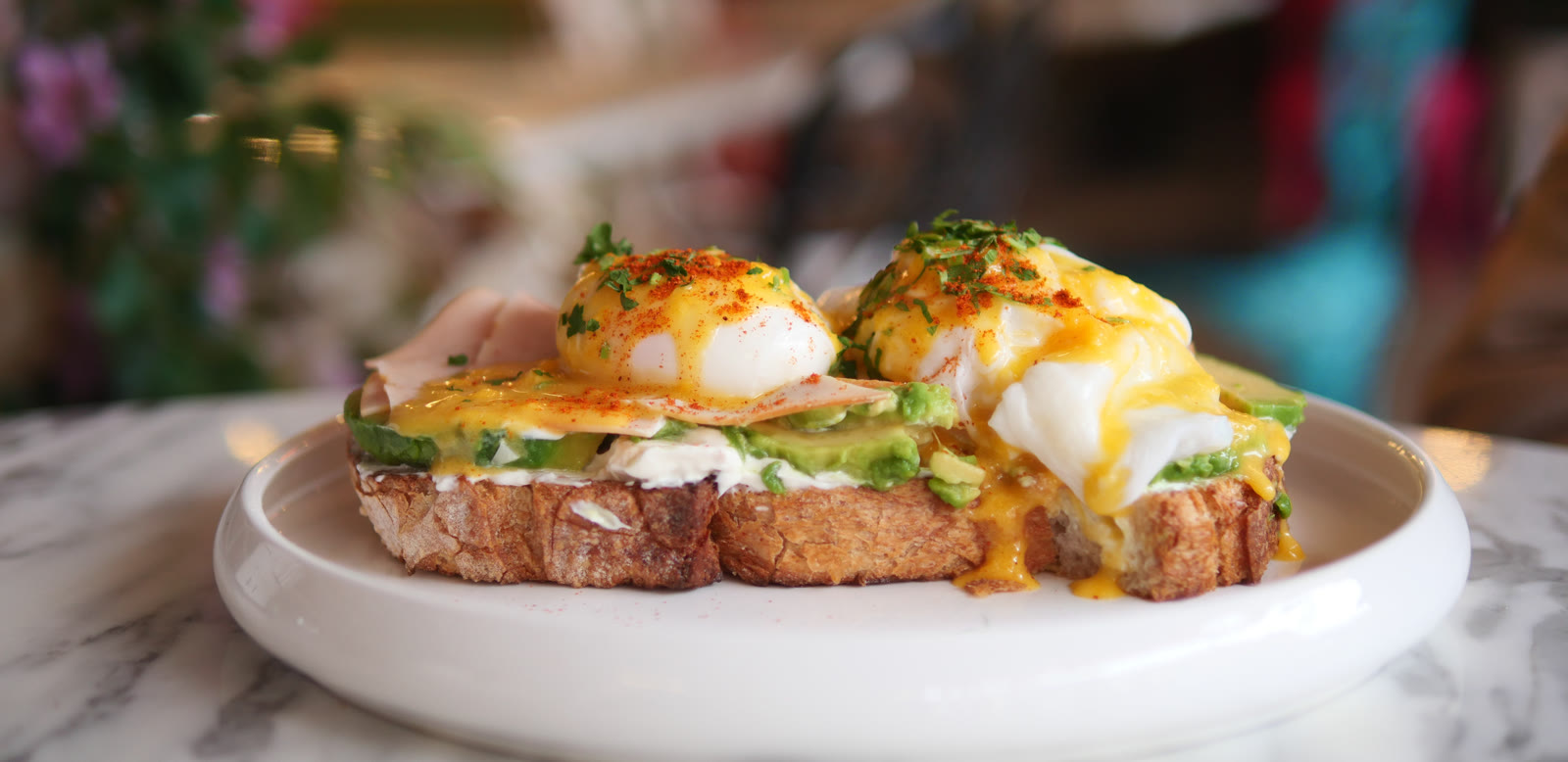 Eggs Benedict with avocado on toasted bread