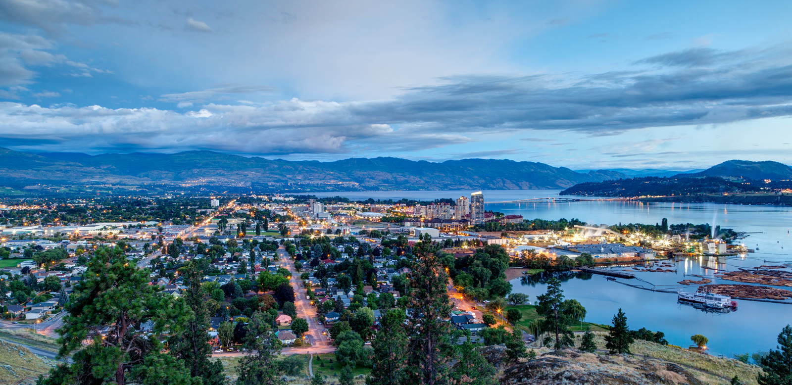 Kelowna and Okanagan Lake at dusk, with the city lights coming on