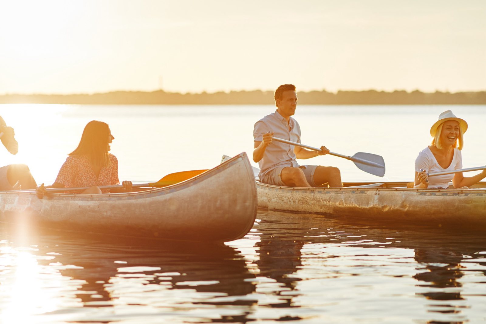 Friends canoeing on a lake on a summer day