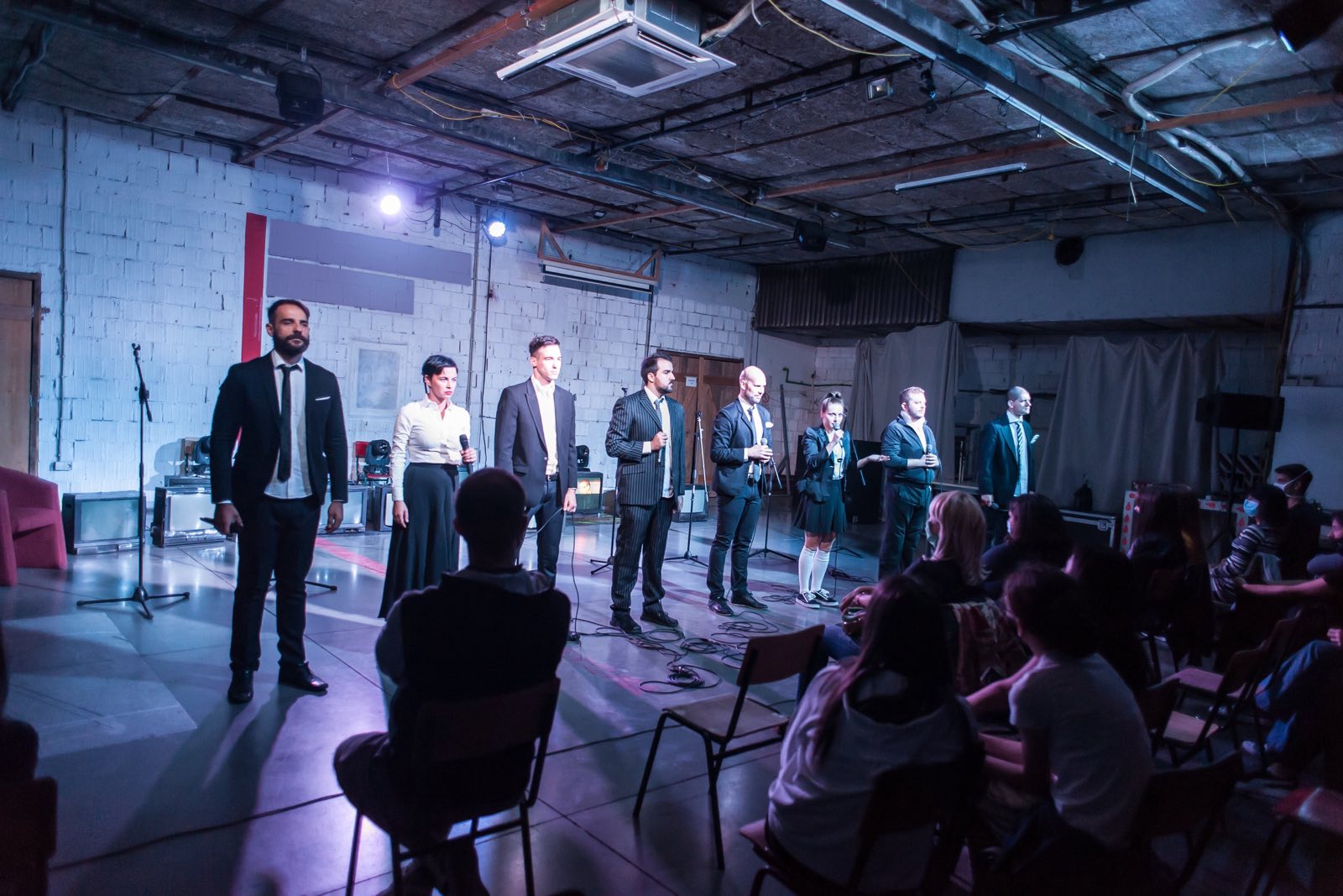 A theatre cast taking a bow on stage