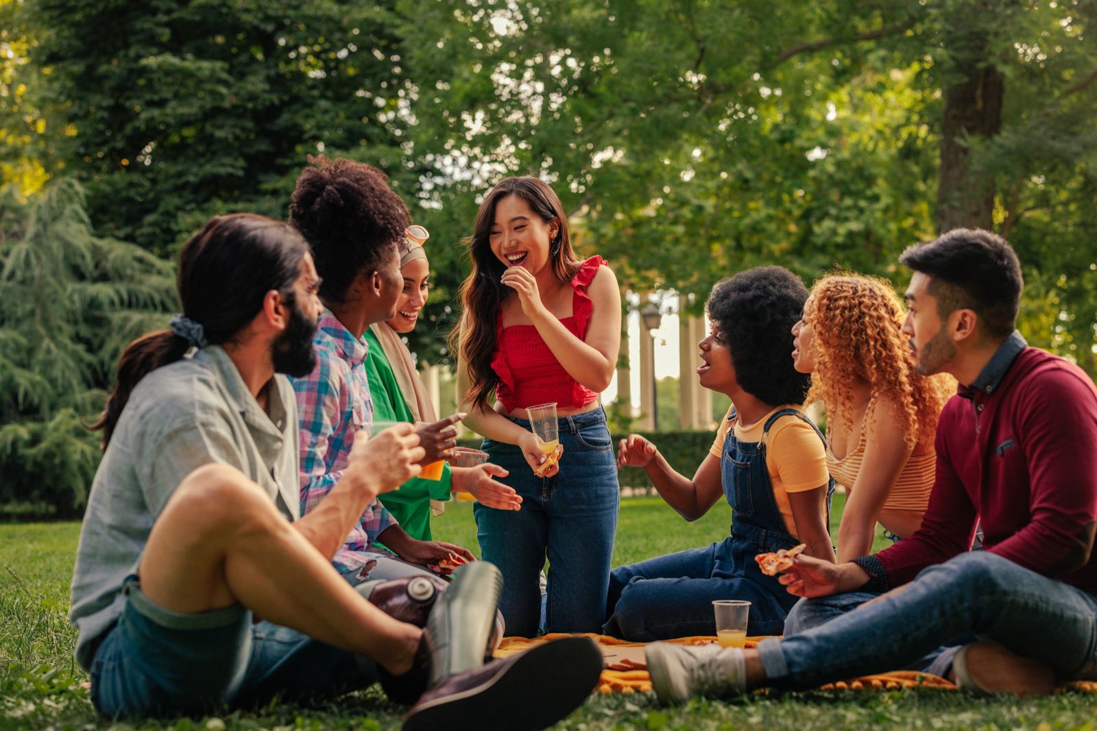 Neighbours chatting at a community gathering in a park