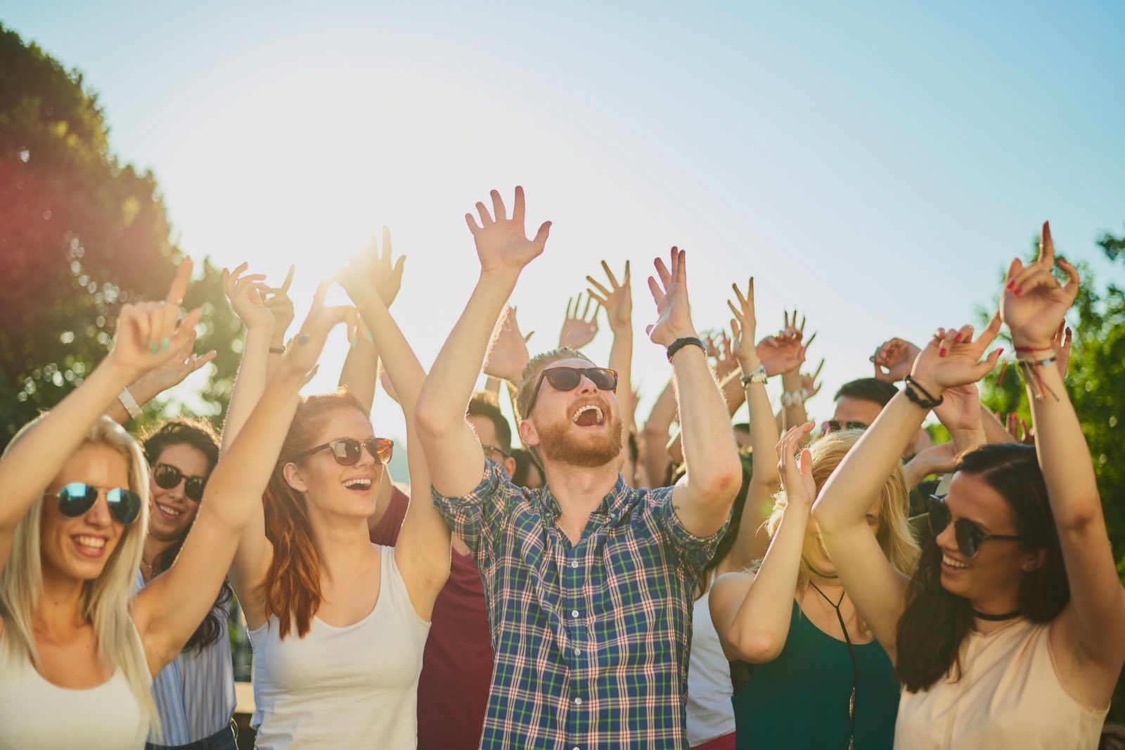 Friends dancing at an outdoor summer festival