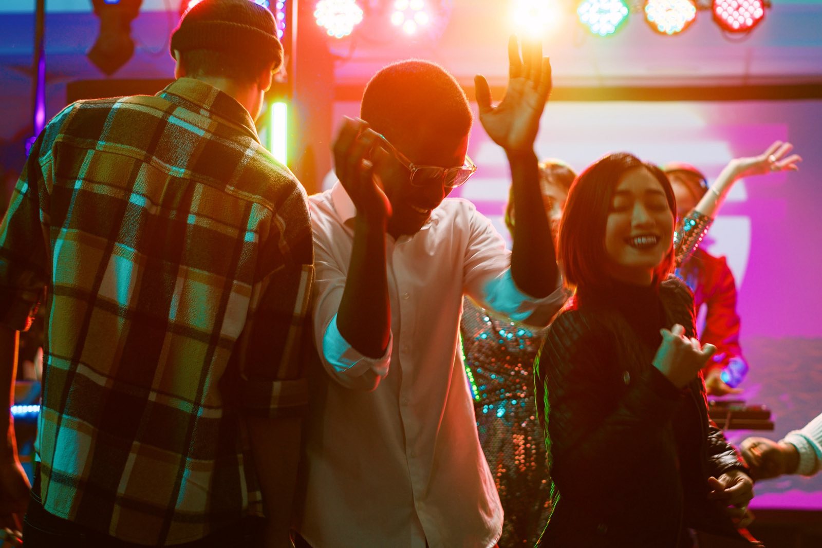 Friends dancing on a nightclub dance floor
